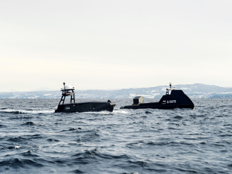 Two uncrewed surface vessels (Mariner and Mariner X) by Maritime Robotics operating together in open sea.