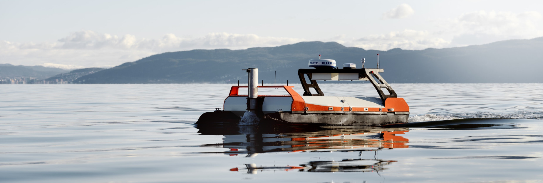 Perspective view of the Otter X USV navigating across the Norwegian fjord.
