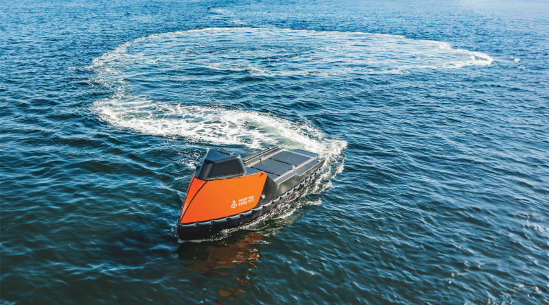 Aerial top sided view of the orange-colored Mariner X  navigating the ocean.