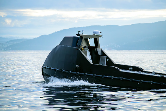Side-back view of the Mariner X USV navigating the open ocean.