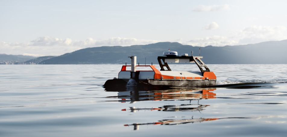 A photo of the Otter X USV surveying the fjord.